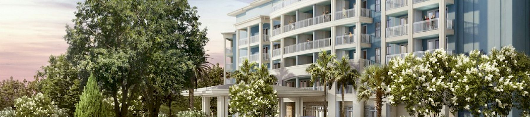 The image shows a luxurious resort entrance with landscaped gardens and a main building in the background at Wild Dunes Resort.