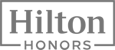 The image shows the "Hilton Honors" logo, featuring the words "Hilton Honors" in a stylized font within a rectangular border.