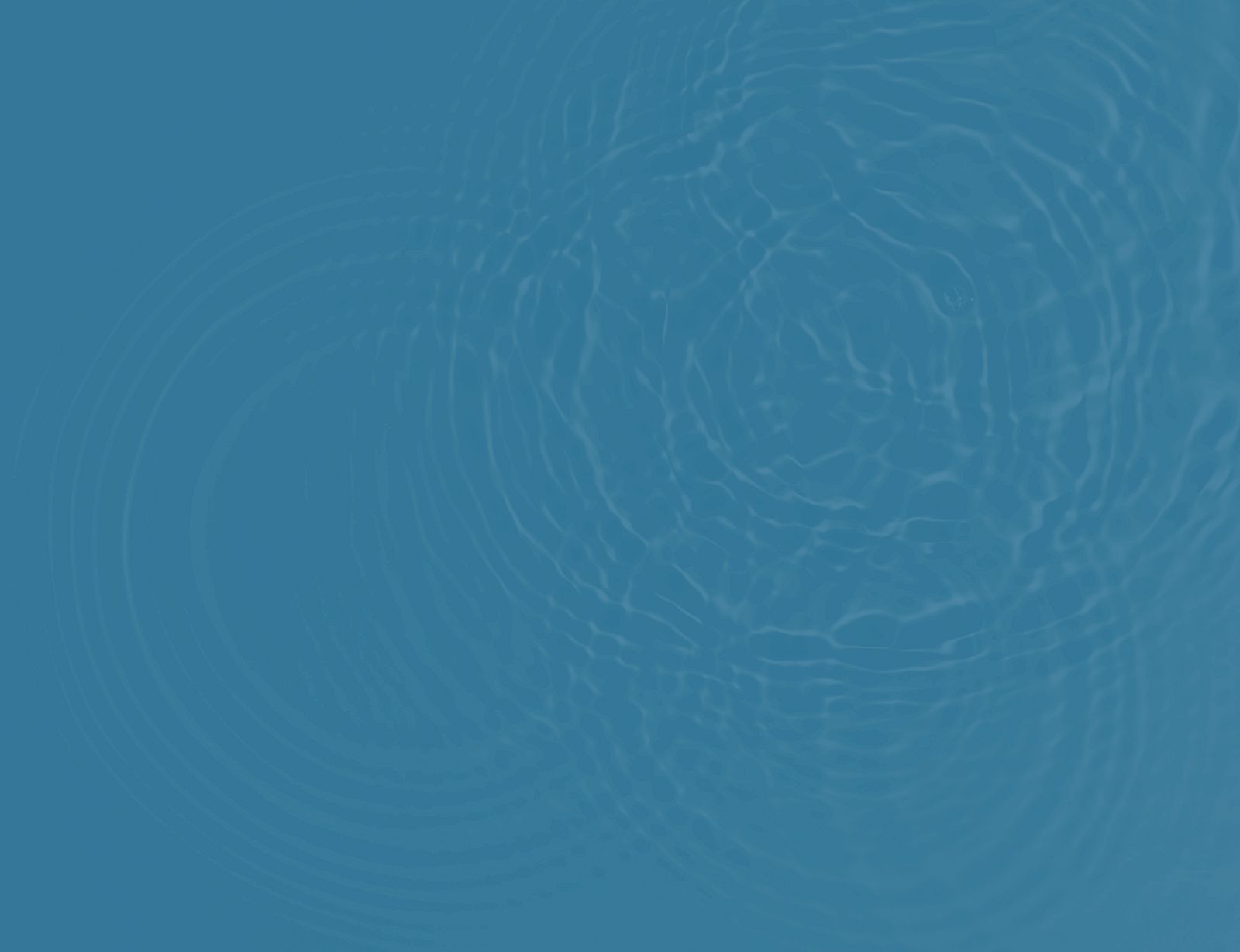 The image shows blue water with circular ripples spreading on the surface.