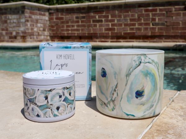 The image shows three containers with decorative designs placed on a patio near a swimming pool, featuring blue and white patterns.