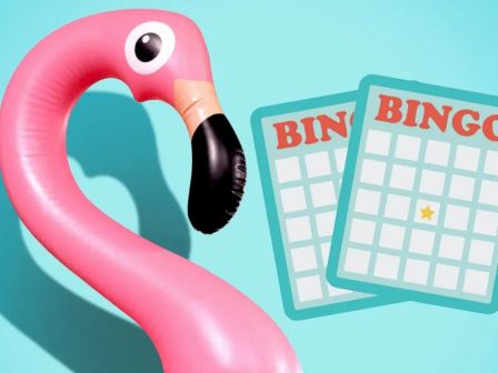 A pink inflatable flamingo and two bingo cards with a star on one against a blue background.